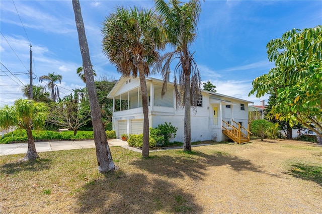 216 Dune Cir, New Smyrna Beach, FL 32169 - view of property exterior featuring concrete driveway and a garage