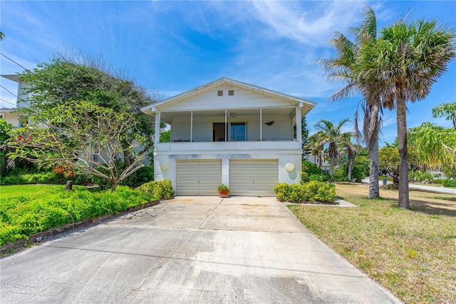 216 Dune Cir, New Smyrna Beach, FL 32169 - coastal home with a front yard, driveway, and an attached garage