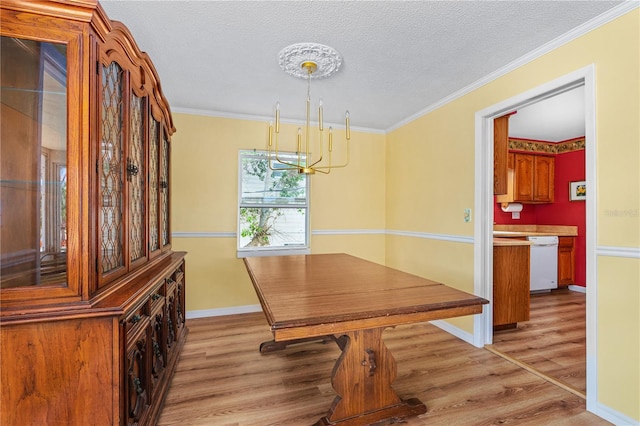 216 Dune Cir, New Smyrna Beach, FL 32169 - unfurnished dining area with light wood-style floors, ornamental molding, baseboards, a notable chandelier, and a textured ceiling