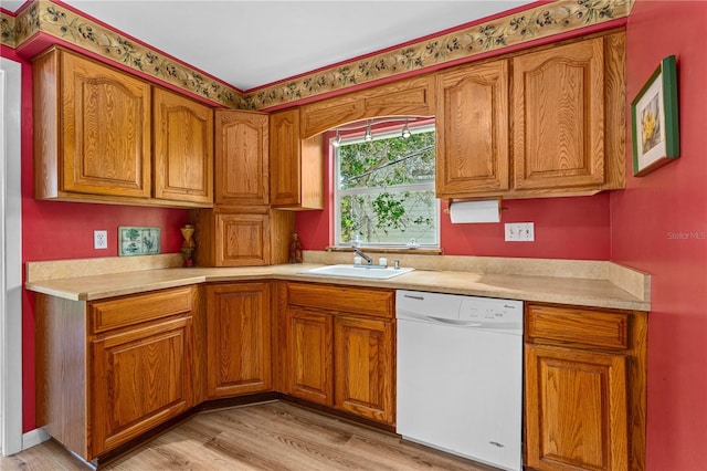 216 Dune Cir, New Smyrna Beach, FL 32169 - kitchen with a sink, brown cabinets, light countertops, and white dishwasher