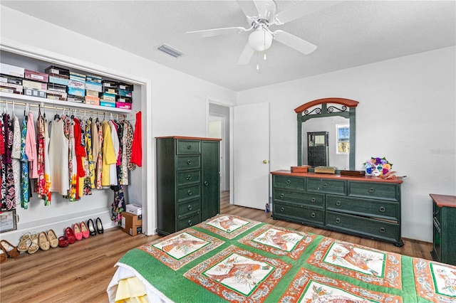 216 Dune Cir, New Smyrna Beach, FL 32169 - bedroom with wood finished floors, visible vents, a ceiling fan, and a closet