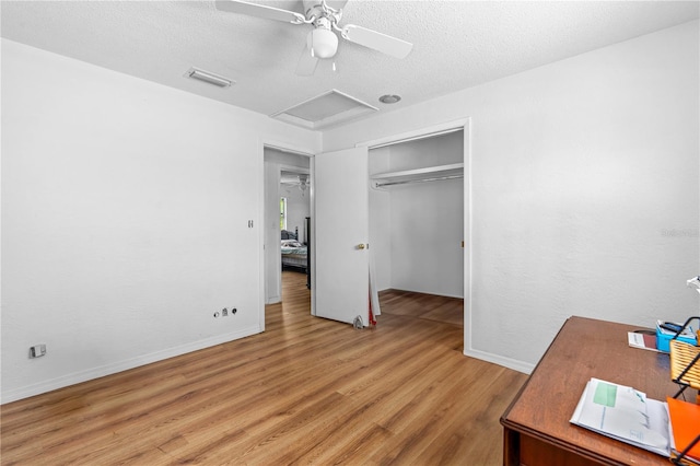 216 Dune Cir, New Smyrna Beach, FL 32169 - unfurnished bedroom with a textured ceiling, light wood-style flooring, visible vents, a closet, and attic access