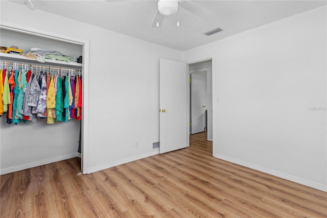 216 Dune Cir, New Smyrna Beach, FL 32169 - unfurnished bedroom with baseboards, visible vents, wood finished floors, and ceiling fan