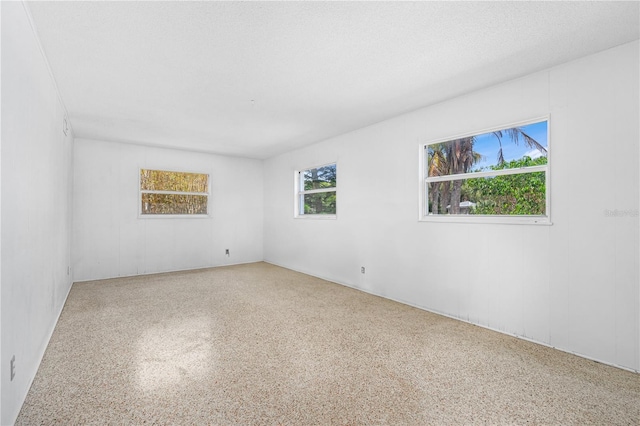 216 Dune Cir, New Smyrna Beach, FL 32169 - spare room featuring speckled floor