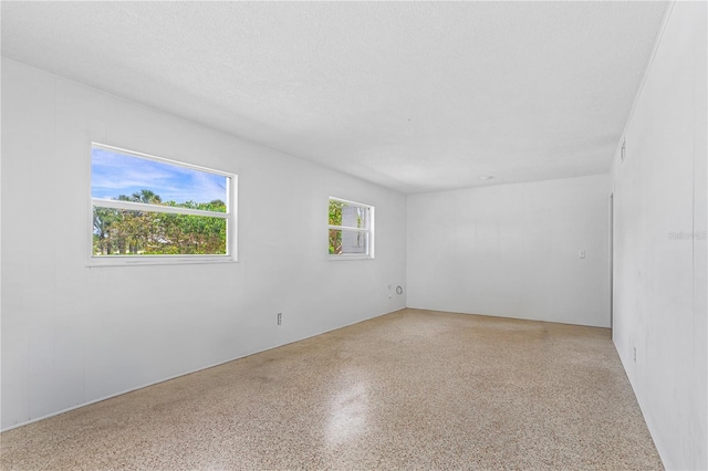 216 Dune Cir, New Smyrna Beach, FL 32169 - spare room with speckled floor