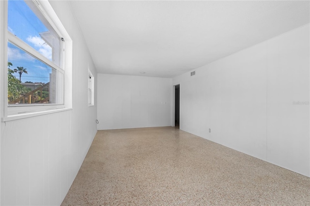 216 Dune Cir, New Smyrna Beach, FL 32169 - spare room featuring visible vents and speckled floor