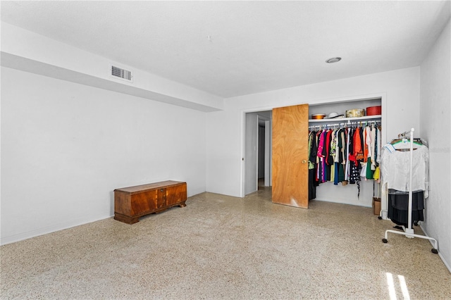 216 Dune Cir, New Smyrna Beach, FL 32169 - unfurnished bedroom featuring baseboards, visible vents, speckled floor, and a closet