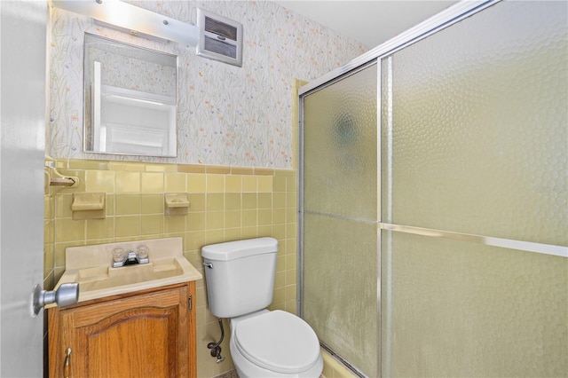 216 Dune Cir, New Smyrna Beach, FL 32169 - bathroom featuring wallpapered walls, a shower stall, a wainscoted wall, toilet, and visible vents