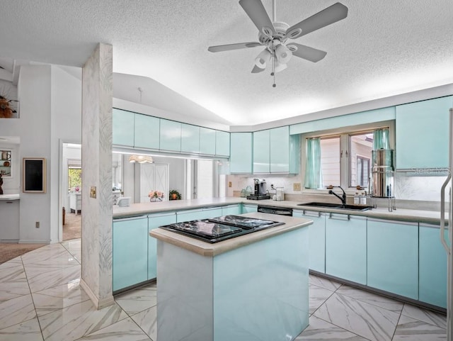 kitchen featuring black stovetop, a kitchen island, light countertops, and marble finish floor