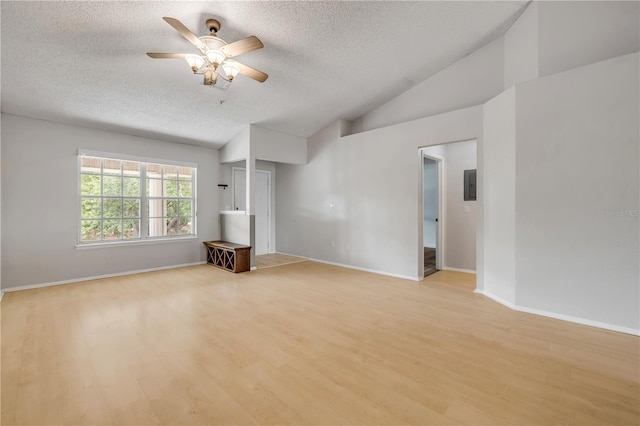 160 Reserve Cir Unit 204, Oviedo, FL 32765 - unfurnished living room with ceiling fan, a textured ceiling, baseboards, light wood-type flooring, and vaulted ceiling