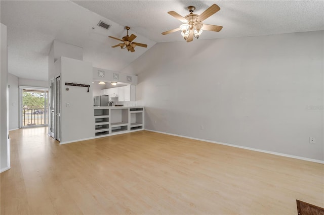 160 Reserve Cir Unit 204, Oviedo, FL 32765 - unfurnished living room with visible vents, baseboards, light wood-style floors, a textured ceiling, and a ceiling fan
