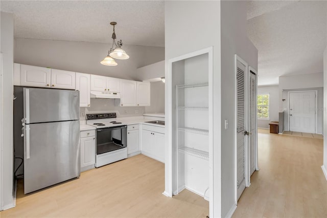 160 Reserve Cir Unit 204, Oviedo, FL 32765 - kitchen with vaulted ceiling, white cabinets, freestanding refrigerator, electric stove, and under cabinet range hood