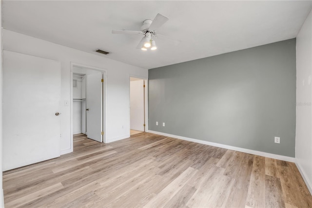 160 Reserve Cir Unit 204, Oviedo, FL 32765 - unfurnished bedroom with baseboards, light wood-type flooring, a spacious closet, and visible vents