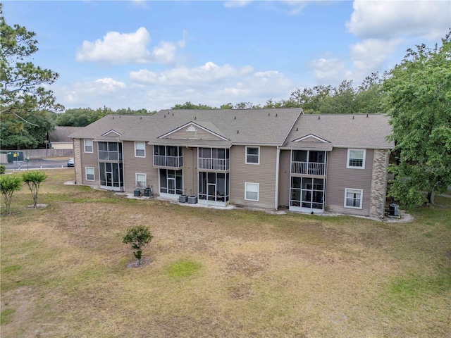 160 Reserve Cir Unit 204, Oviedo, FL 32765 - rear view of property with a yard, a sunroom, and central AC