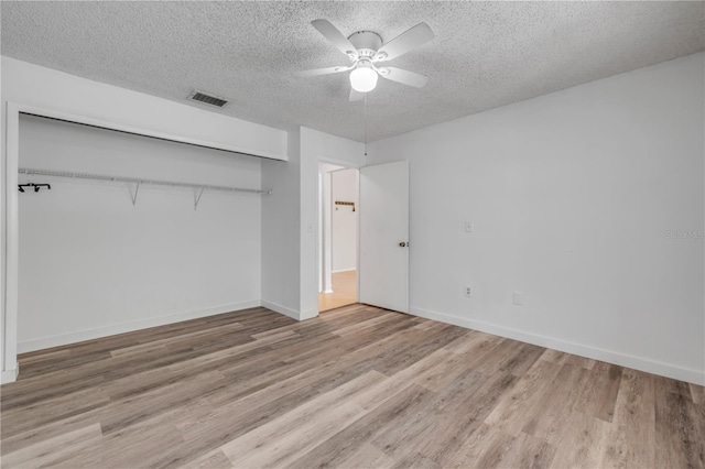 160 Reserve Cir Unit 204, Oviedo, FL 32765 - unfurnished bedroom featuring a textured ceiling, visible vents, wood finished floors, baseboards, and a closet