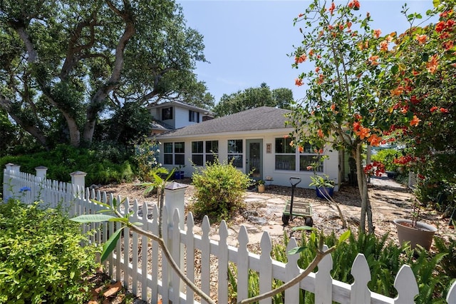 825 E 23rd Ave, New Smyrna Beach, FL 32169 - back of house featuring a fenced front yard and a shingled roof