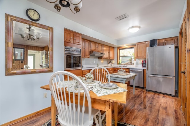 825 E 23rd Ave, New Smyrna Beach, FL 32169 - kitchen featuring a sink, light countertops, a chandelier, stainless steel appliances, and visible vents