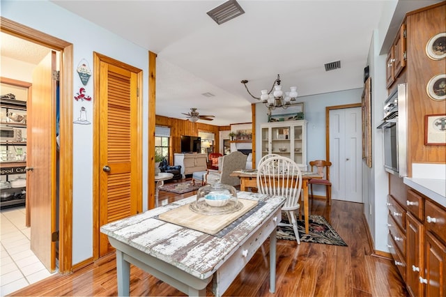 825 E 23rd Ave, New Smyrna Beach, FL 32169 - dining room featuring baseboards, ceiling fan with notable chandelier, wood finished floors, and visible vents