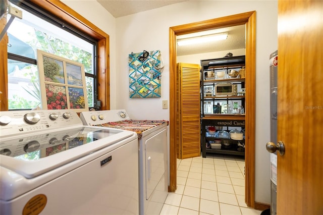 825 E 23rd Ave, New Smyrna Beach, FL 32169 - laundry room with washing machine and clothes dryer, light tile patterned flooring, laundry area, and a textured ceiling
