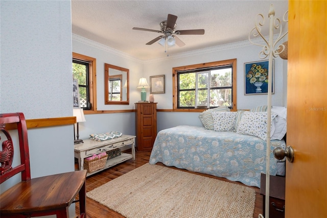 825 E 23rd Ave, New Smyrna Beach, FL 32169 - bedroom with ornamental molding, a textured ceiling, a ceiling fan, and wood finished floors