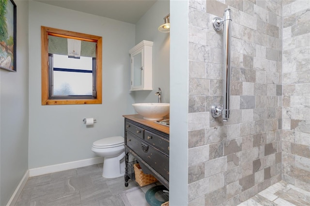825 E 23rd Ave, New Smyrna Beach, FL 32169 - bathroom with vanity, baseboards, a tile shower, and toilet