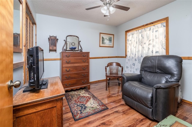 825 E 23rd Ave, New Smyrna Beach, FL 32169 - living area with baseboards, a textured ceiling, ceiling fan, and wood finished floors