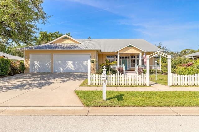 2815 Bay Side Dr, New Smyrna Beach, FL 32168 - single story home with driveway, covered porch, a fenced front yard, and a garage