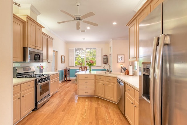 2815 Bay Side Dr, New Smyrna Beach, FL 32168 - kitchen featuring light brown cabinetry, stainless steel appliances, light countertops, ornamental molding, and a sink