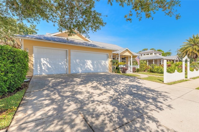 2815 Bay Side Dr, New Smyrna Beach, FL 32168 - single story home with covered porch, driveway, and an attached garage