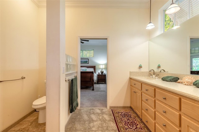 2815 Bay Side Dr, New Smyrna Beach, FL 32168 - bathroom with crown molding, plenty of natural light, toilet, vanity, and ensuite bath