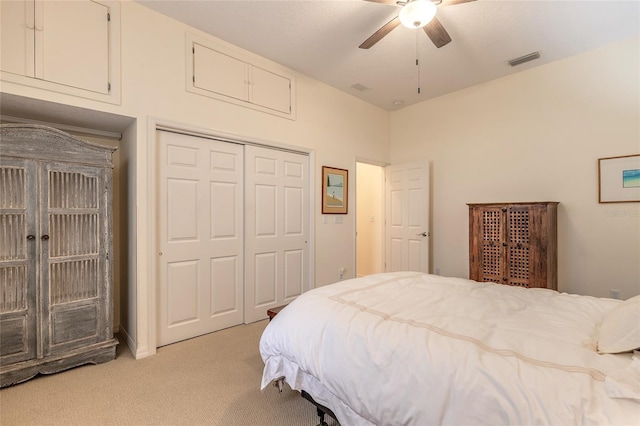 2815 Bay Side Dr, New Smyrna Beach, FL 32168 - bedroom featuring a closet, visible vents, a ceiling fan, and light colored carpet