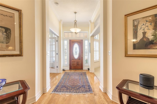 2815 Bay Side Dr, New Smyrna Beach, FL 32168 - entryway with baseboards, ornamental molding, and light wood-style floors