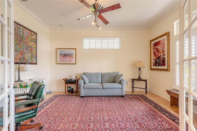 2815 Bay Side Dr, New Smyrna Beach, FL 32168 - living room with wood finished floors, ceiling fan, ornamental molding, and baseboards