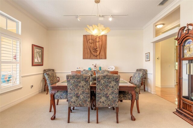 2815 Bay Side Dr, New Smyrna Beach, FL 32168 - dining space featuring track lighting, visible vents, ornamental molding, and carpet
