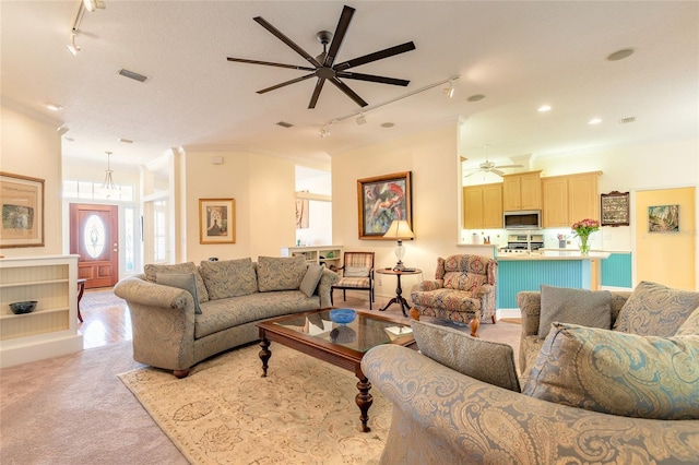 2815 Bay Side Dr, New Smyrna Beach, FL 32168 - living room with crown molding, ceiling fan, rail lighting, and visible vents