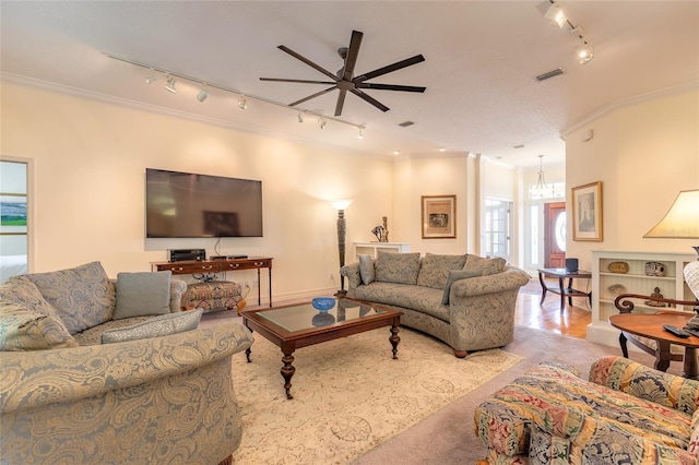 2815 Bay Side Dr, New Smyrna Beach, FL 32168 - living room featuring track lighting, visible vents, ceiling fan, and crown molding