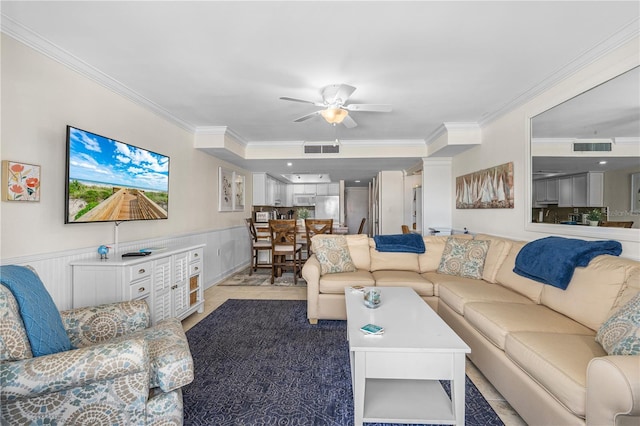 4841 Saxon Dr Unit C201, New Smyrna Beach, FL 32169 - living room with wainscoting, a ceiling fan, visible vents, and ornamental molding
