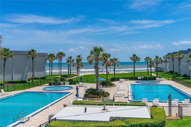 4841 Saxon Dr Unit C201, New Smyrna Beach, FL 32169 - pool featuring a patio, a hot tub, and fence