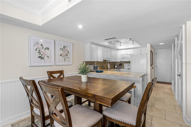 4841 Saxon Dr Unit C201, New Smyrna Beach, FL 32169 - dining space featuring stone tile floors, recessed lighting, ornamental molding, and a raised ceiling