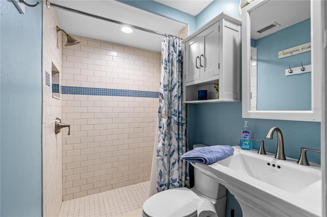 4841 Saxon Dr Unit C201, New Smyrna Beach, FL 32169 - bathroom with visible vents, a sink, a stall shower, and toilet
