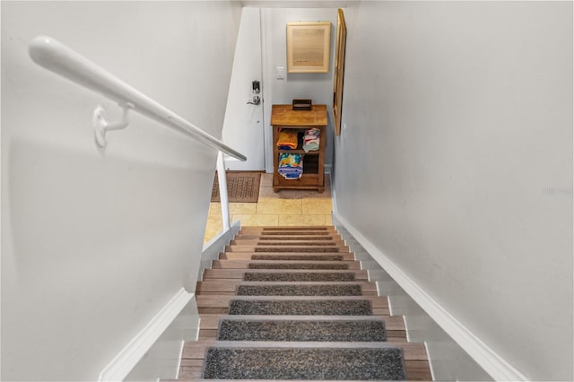 4841 Saxon Dr Unit C201, New Smyrna Beach, FL 32169 - staircase with baseboards and tile patterned floors