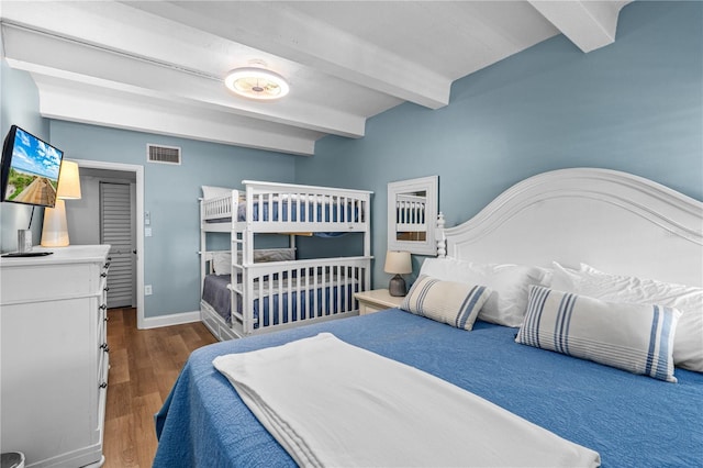 4841 Saxon Dr Unit C201, New Smyrna Beach, FL 32169 - bedroom featuring visible vents, baseboards, beam ceiling, and wood finished floors