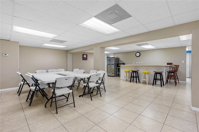 4841 Saxon Dr Unit C201, New Smyrna Beach, FL 32169 - dining area with baseboards, light tile patterned floors, a drop ceiling, and a community bar