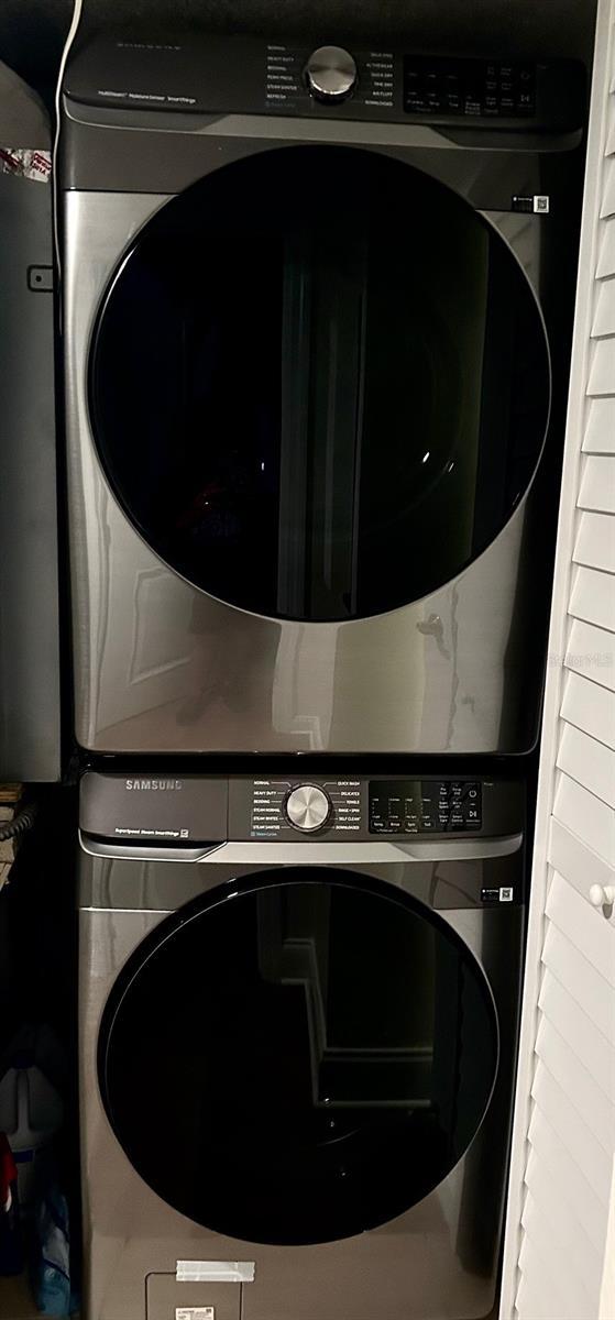 4841 Saxon Dr Unit C201, New Smyrna Beach, FL 32169 - clothes washing area with stacked washer / drying machine and laundry area