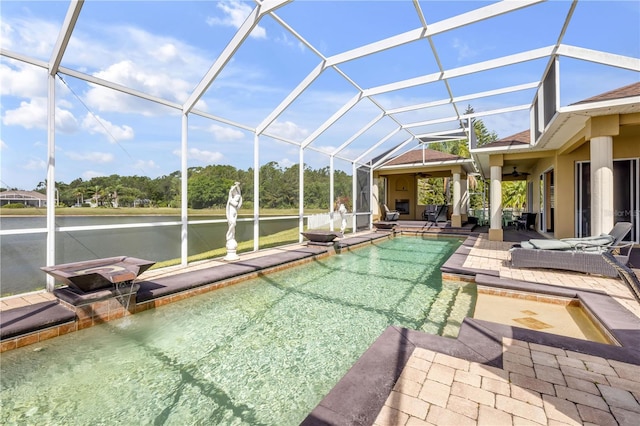 pool with glass enclosure, a patio, a water view, and a ceiling fan
