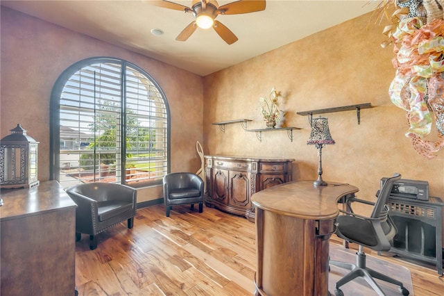 office area featuring ceiling fan, a textured wall, and wood finished floors