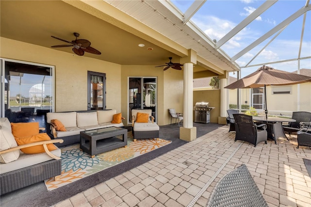 view of patio with grilling area, a ceiling fan, outdoor dining area, a lanai, and outdoor lounge area