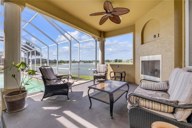 view of patio with ceiling fan, outdoor lounge area, an outdoor pool, a water view, and a lanai