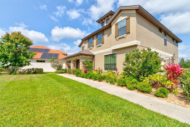 1703 Frogs Leap Ct, Port Orange, FL 32128 - rear view of house featuring stucco siding and a lawn