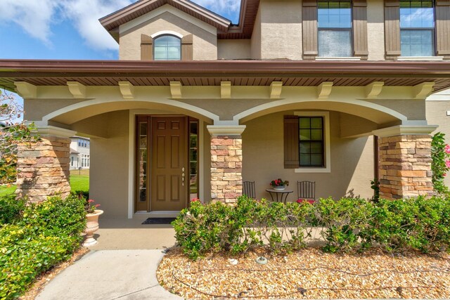 1703 Frogs Leap Ct, Port Orange, FL 32128 - entrance to property featuring stucco siding and a porch